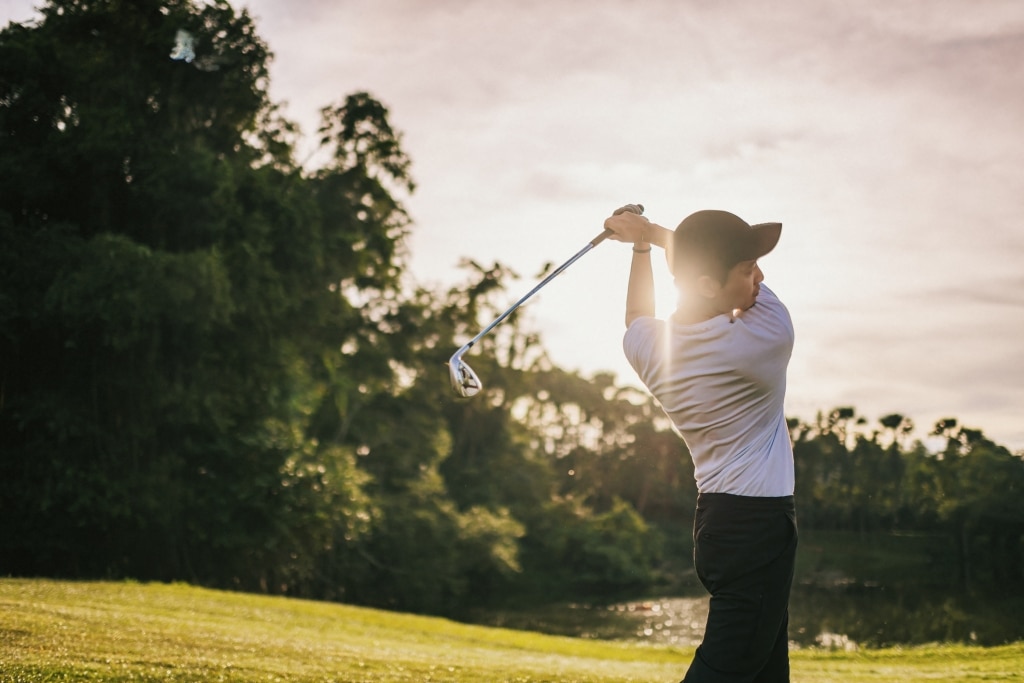 Golfer mid-swing on a course near Breckenridge