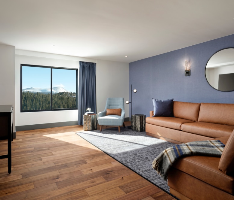 Spacious ADA one-bedroom suite living room with mountain views at Hotel Alpenrock.
