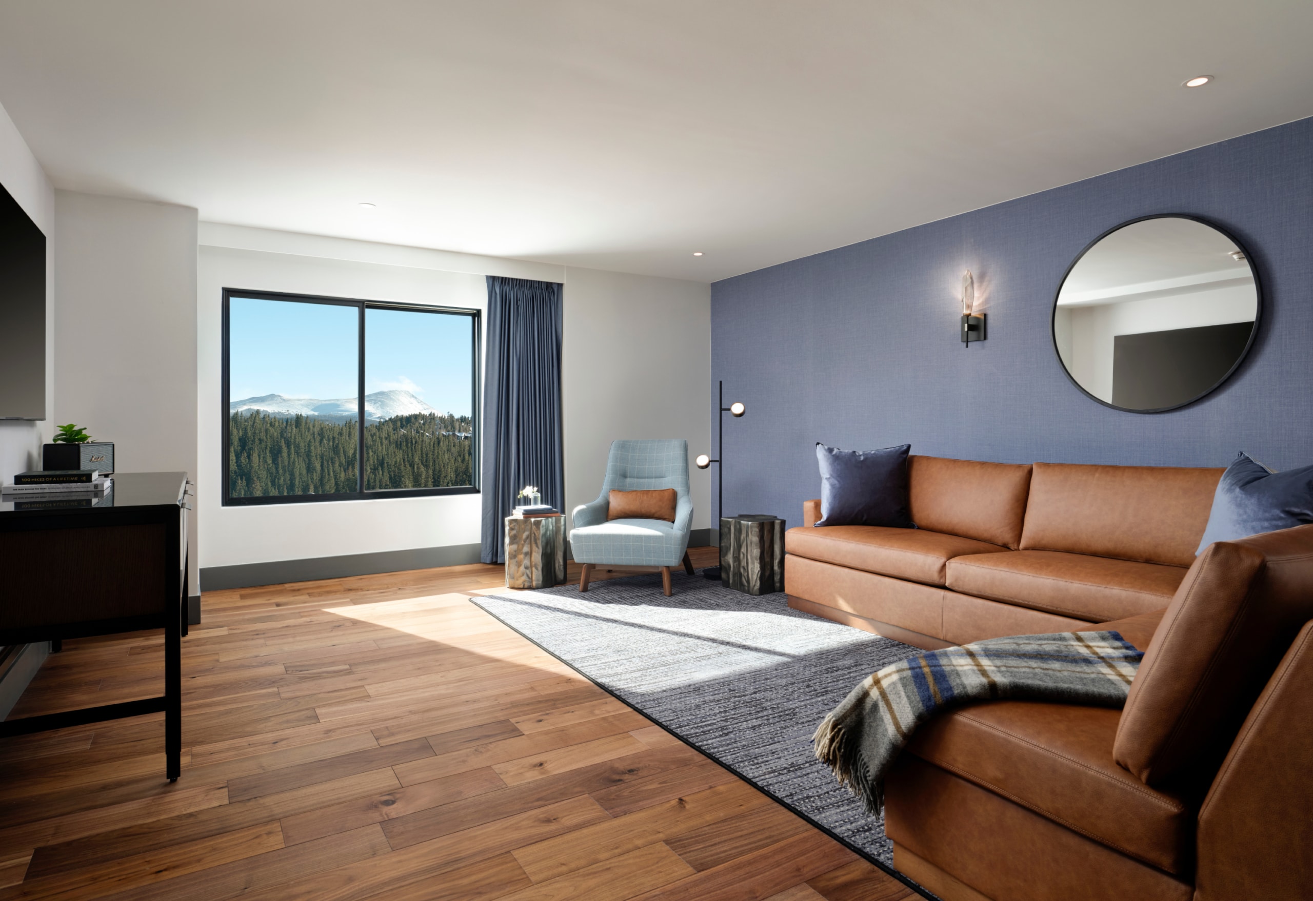 Spacious ADA one-bedroom suite living room with mountain views at Hotel Alpenrock.