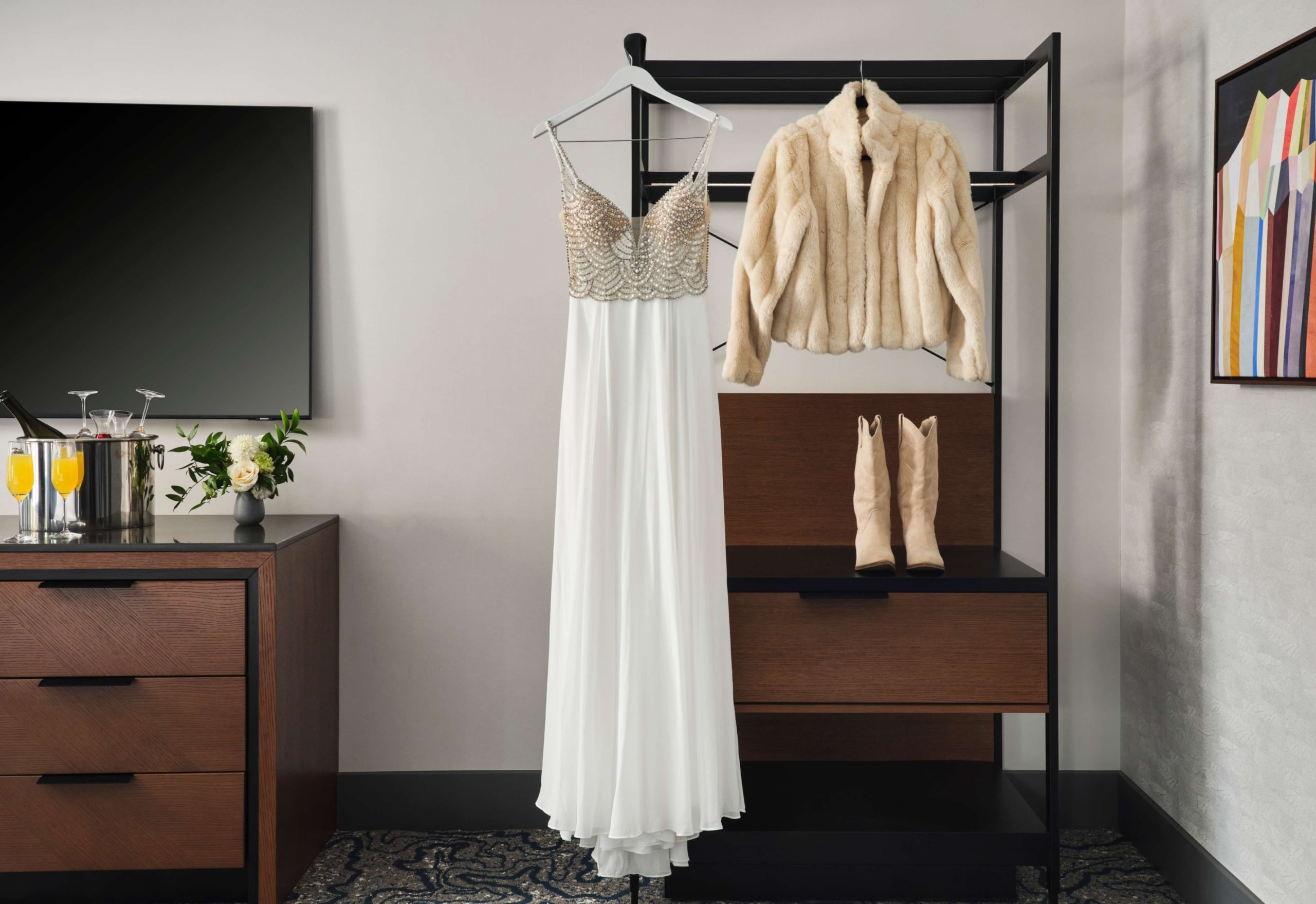 Bridal gown and winter jacket displayed in a Hotel Alpenrock suite, styled for a mountain wedding.