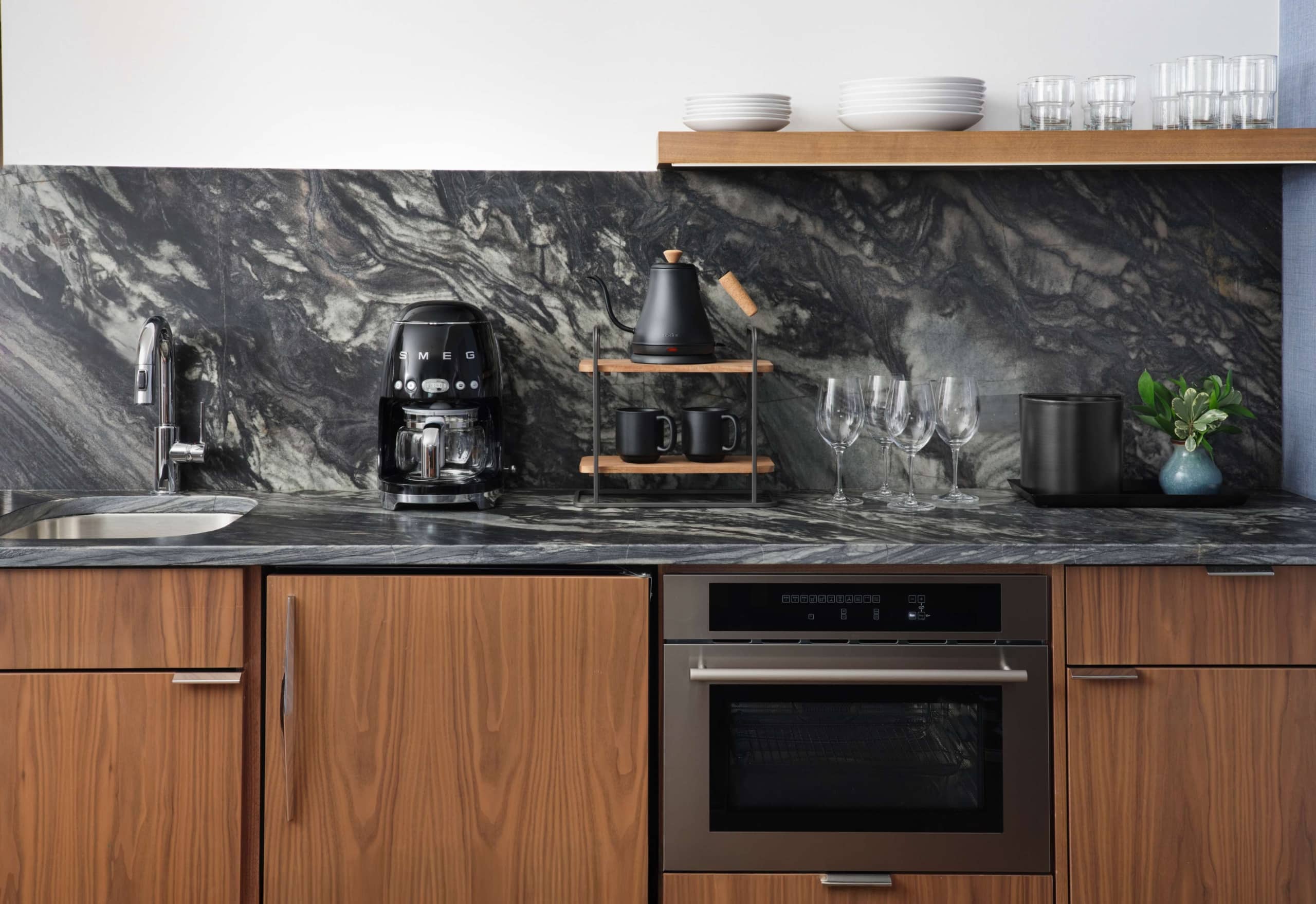 Hotel Alpenrock one-bedroom suite kitchen with marble backsplash, modern appliances, and coffee setup.