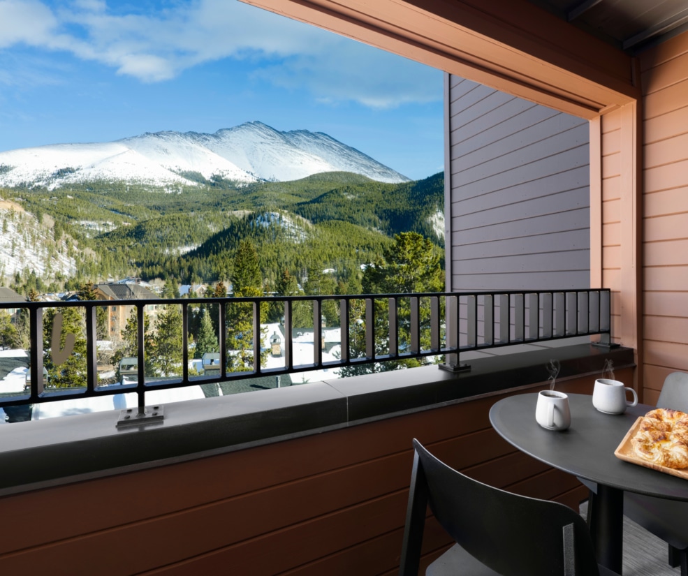 Balcony with coffee and mountain views at Hotel Alpenrock.