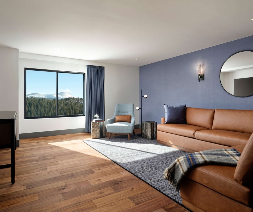 Spacious ADA one-bedroom suite living room with mountain views at Hotel Alpenrock.