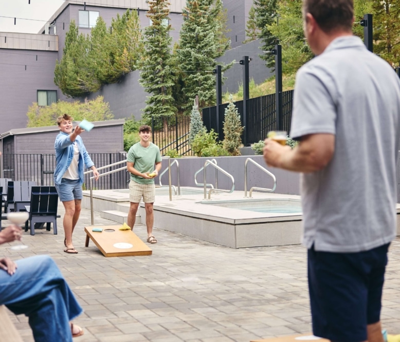 Guests playing outdoor games on the Hotel Alpenrock patio.
