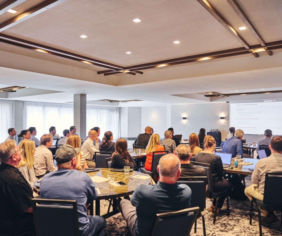Spacious meeting room at Hotel Alpenrock filled with professionals attending a conference presentation.