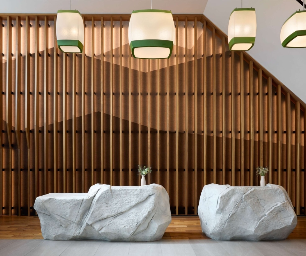 Modern front desk with stone counters in the Hotel Alpenrock lobby.