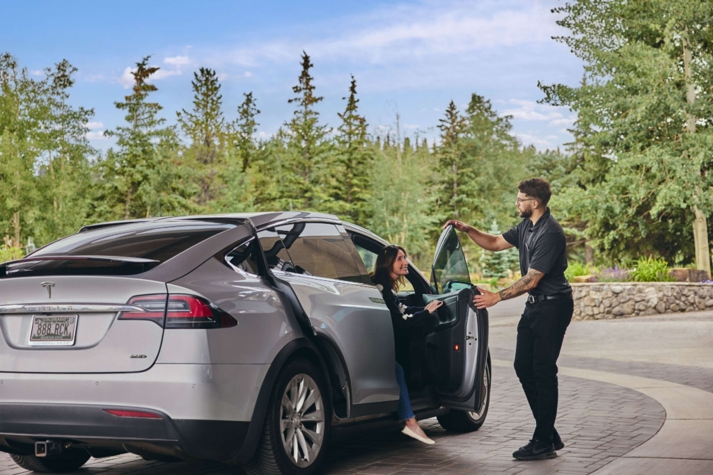 Valet assisting guests with luggage at the Hotel Alpenrock entrance.