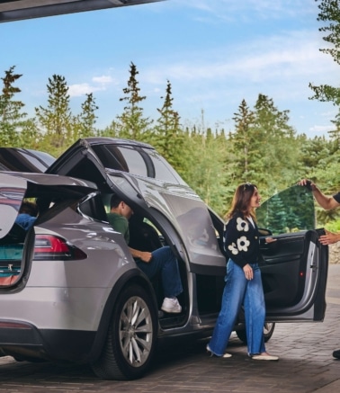 Valet assisting guests with luggage at the Hotel Alpenrock entrance.