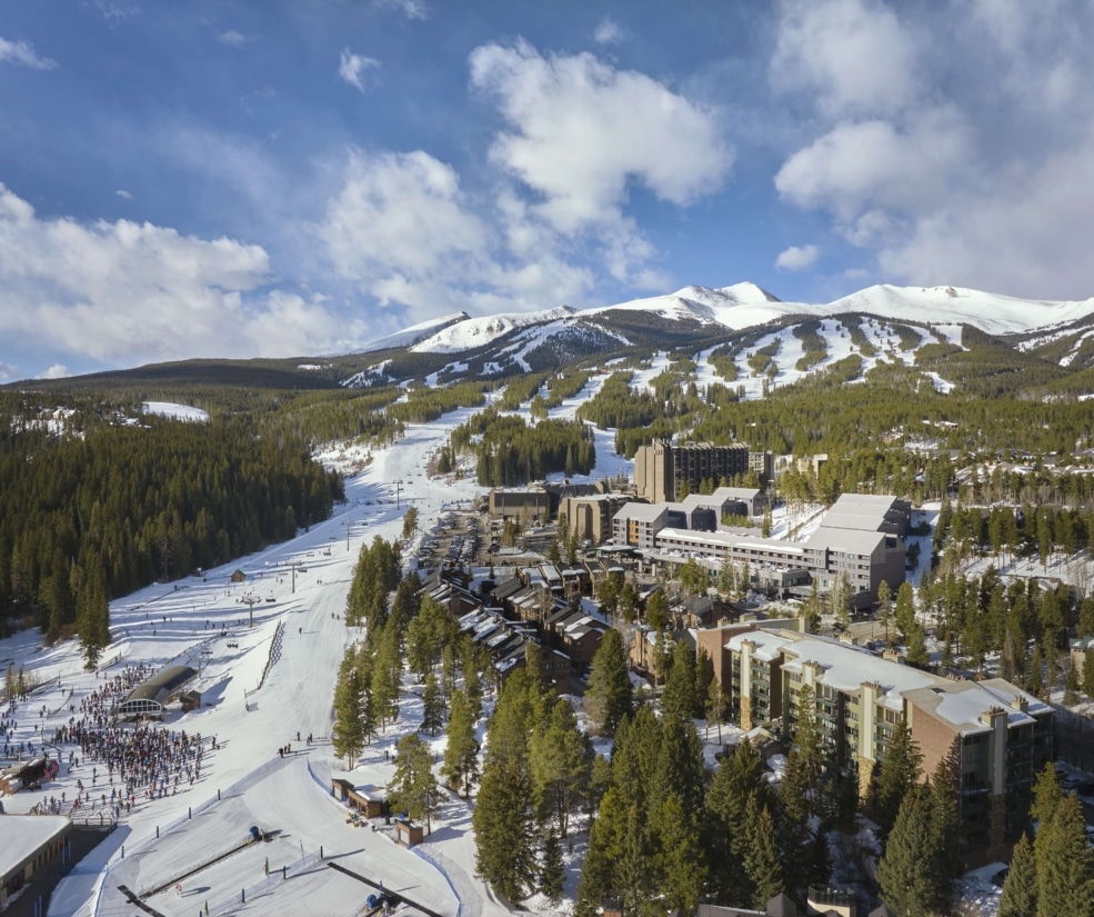 Aerial view of Hotel Alpenrock surrounded by ski lifts, snowy runs, and forested mountain peaks.