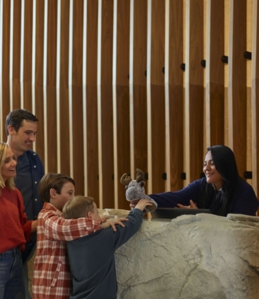 Family checking in with a front desk agent at Hotel Alpenrock.