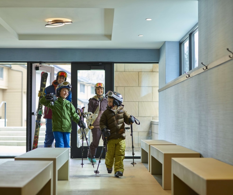 Family arriving at the ski valet area of Hotel Alpenrock.