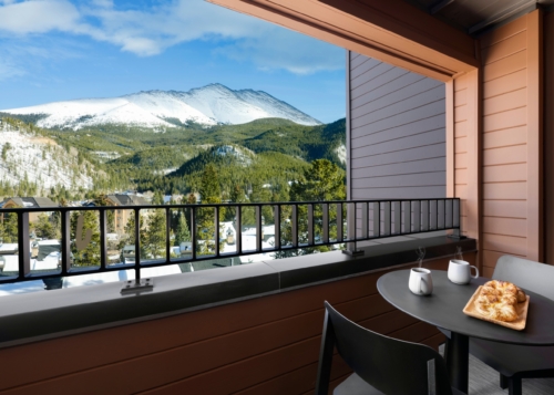 Balcony with coffee and mountain views at Hotel Alpenrock.
