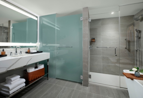 Spacious junior suite bathroom with soaking tub and walk-in shower at Hotel Alpenrock.
